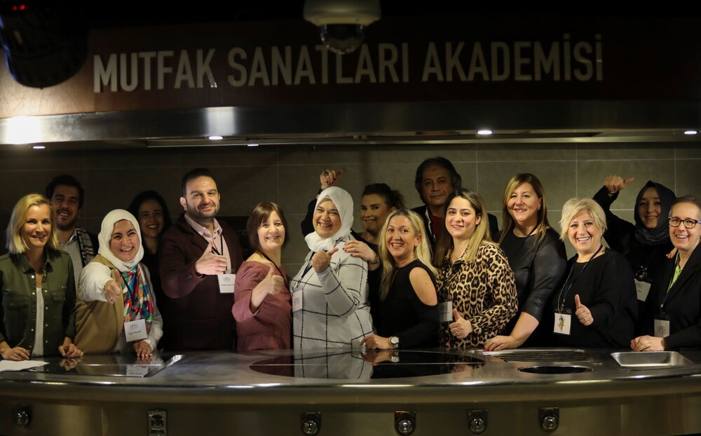 Contributing members celebrate their hard work at the cookbook launch event at MSA Istanbul
